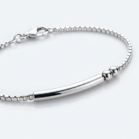 Gros plan sur les perles et la barre argentées du Bracelet Code Morse